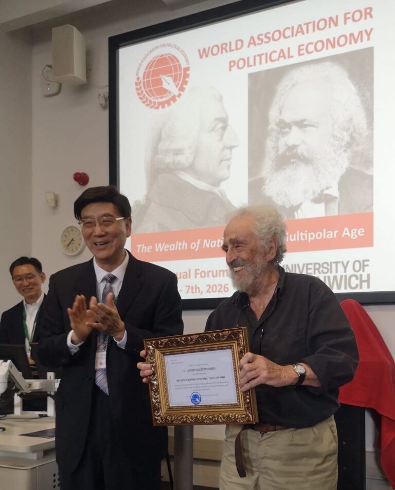 Roger van Zwanenberg receiving the “Distinguished Contribution Award” from Prof. Chen Enfu at the opening plenary of the 19th Annual Forum of WAPE “The Wealth of Nations in the Multipolar Age” which took place from 5 - 7th August at the University of Greenwich, London.